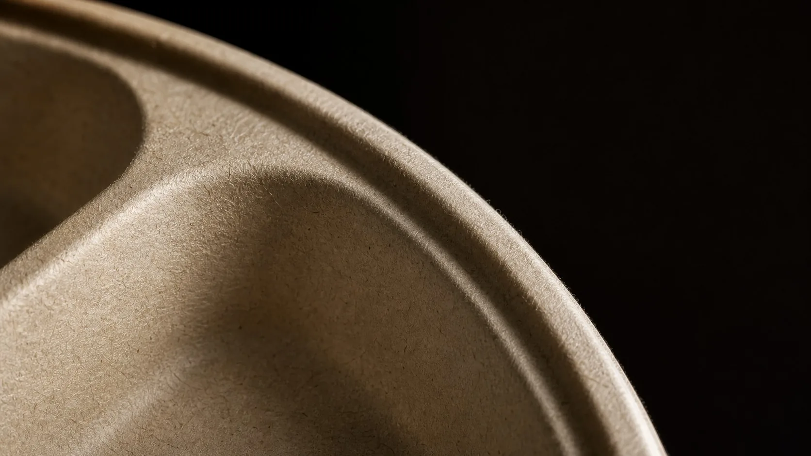 Close view of molded fiber food-packaging material and surface texture